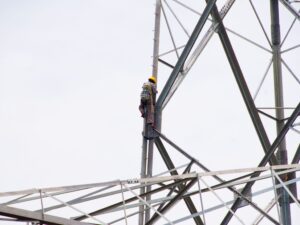 pylon-construction-workers-working-on-the-top-of-p-2024-09-19-01-20-26-utc.jpg