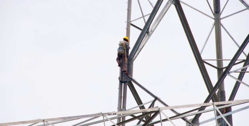 pylon-construction-workers-working-on-the-top-of-p-2024-09-19-01-20-26-utc.jpg